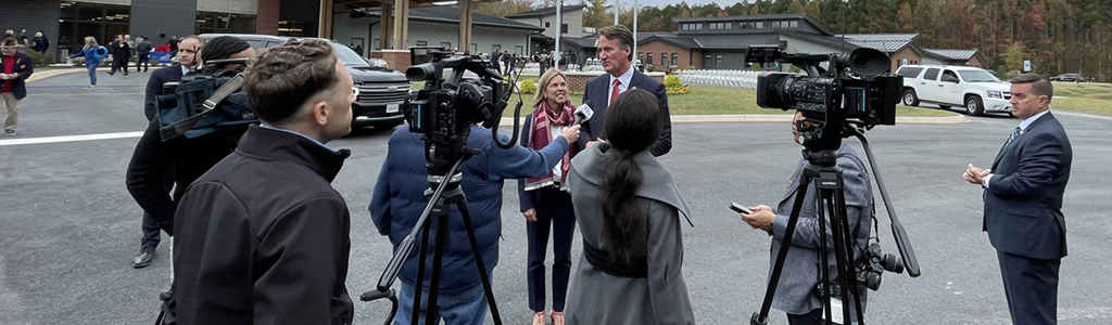 Governor Younkin and First Lady speaking with news crews at Jones & Cabacoy Veterans Care Center grand opening